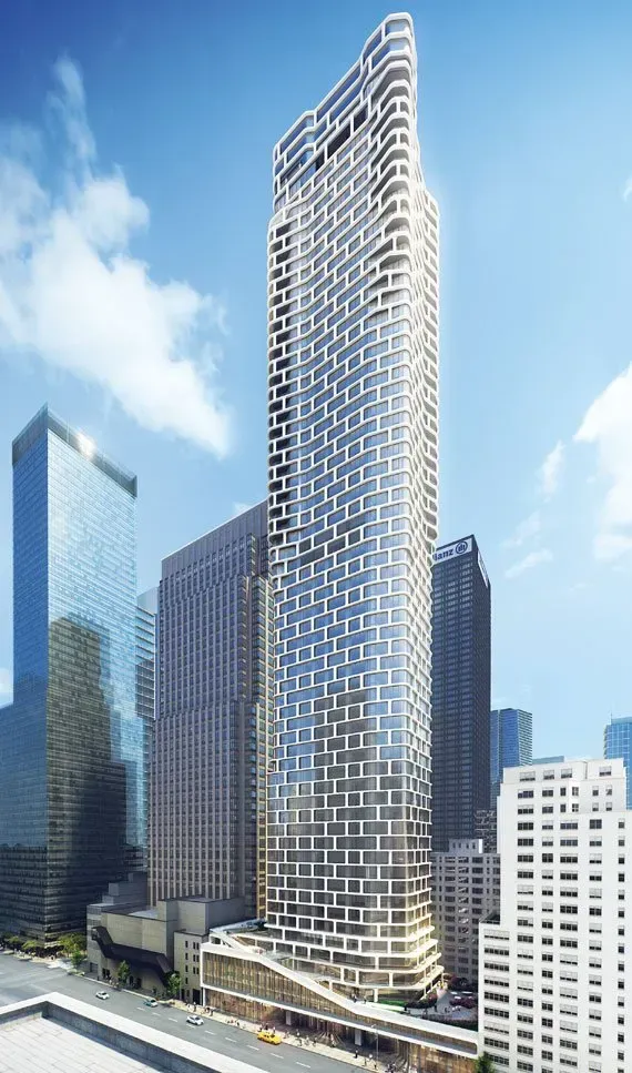 Tall modern skyscraper with a wavy crown against a blue sky in a city skyline