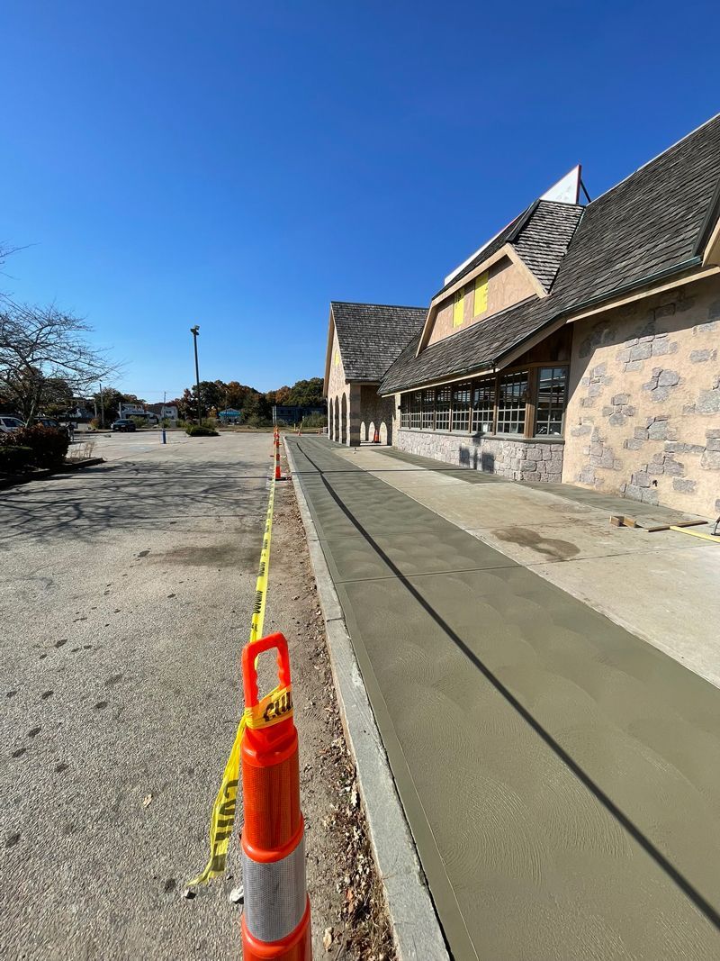 A concrete walkway is being built in front of a building.