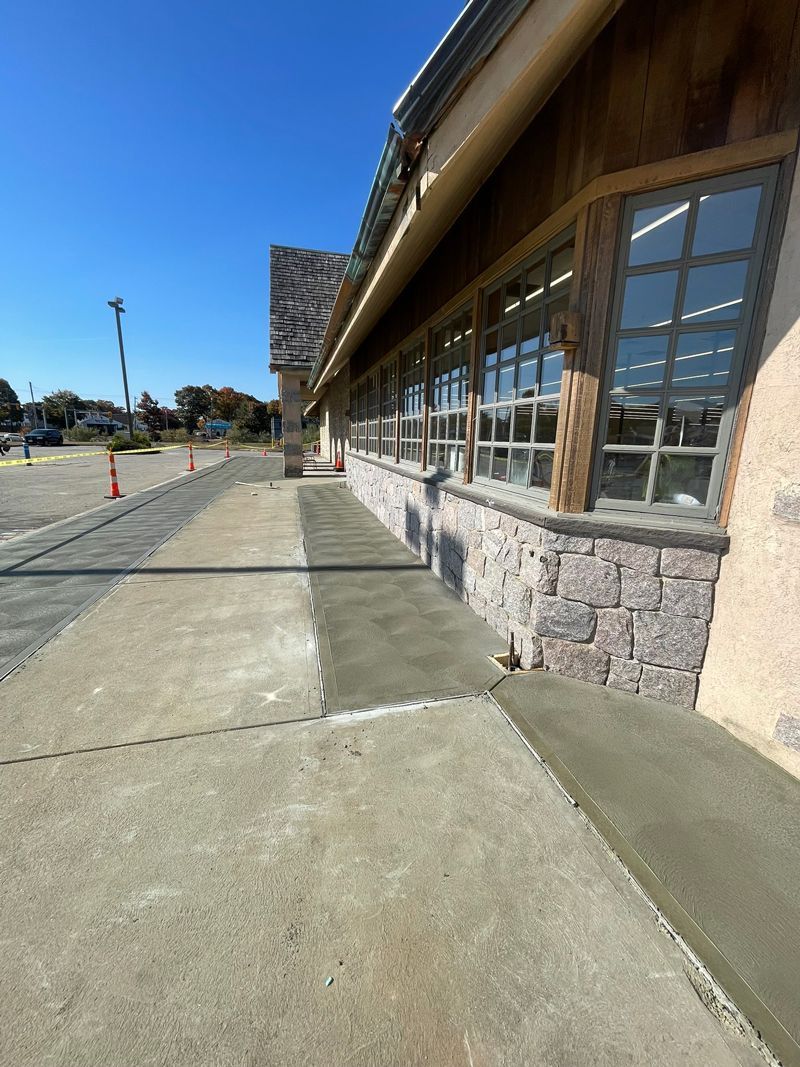A sidewalk is being built in front of a building.
