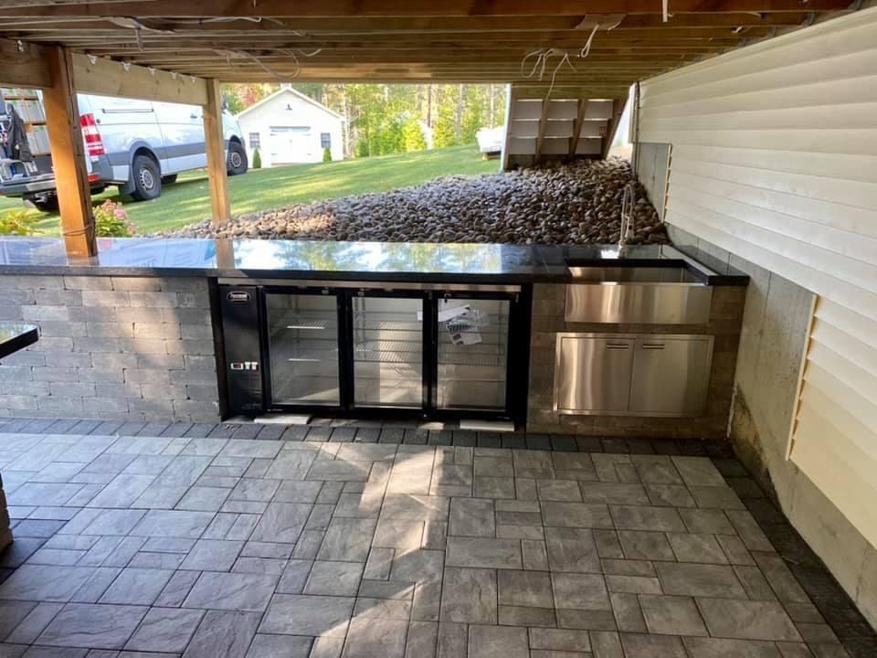 A kitchen with a stainless steel counter top and a refrigerator