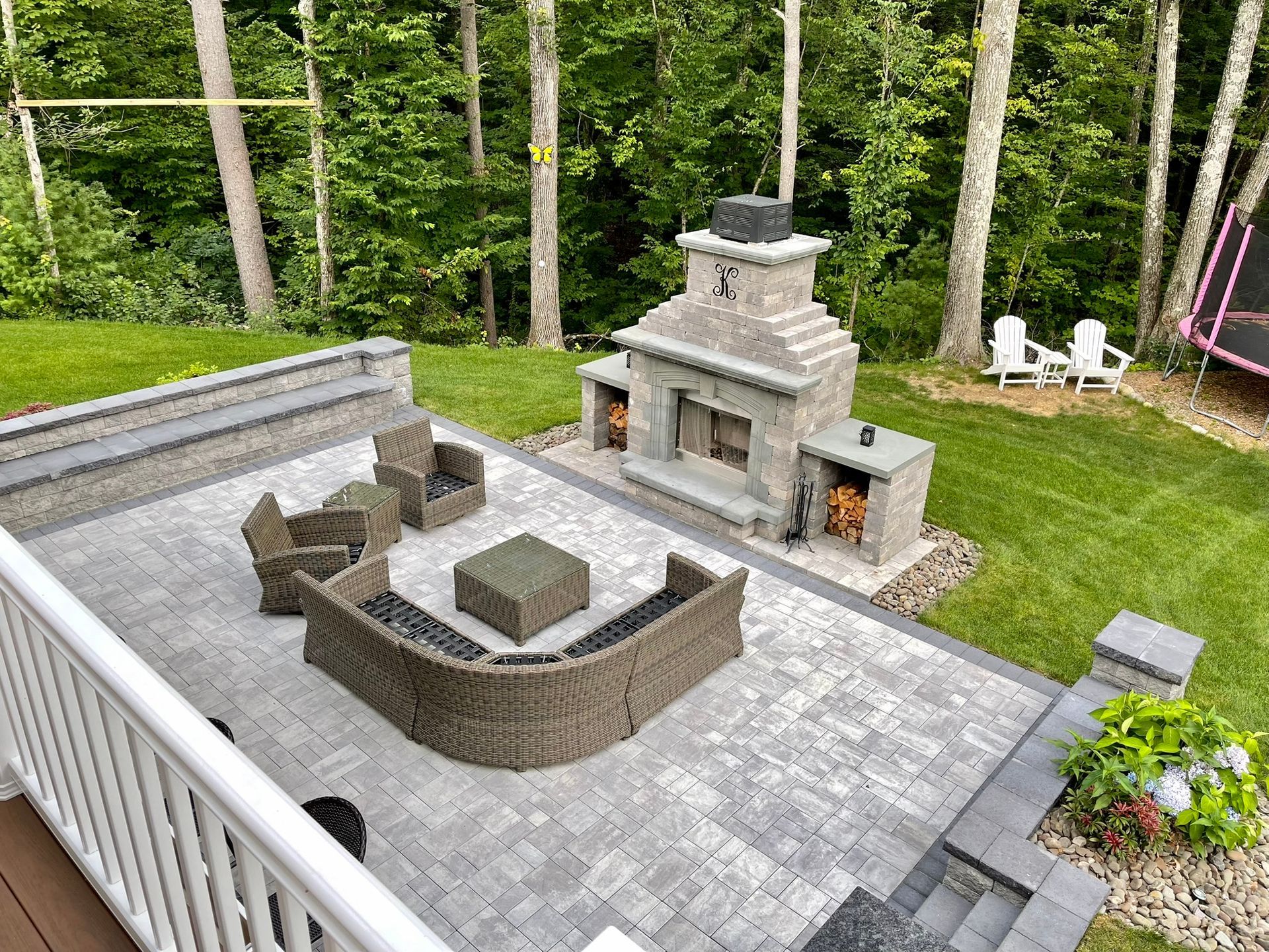 An aerial view of a patio with a fireplace and furniture.