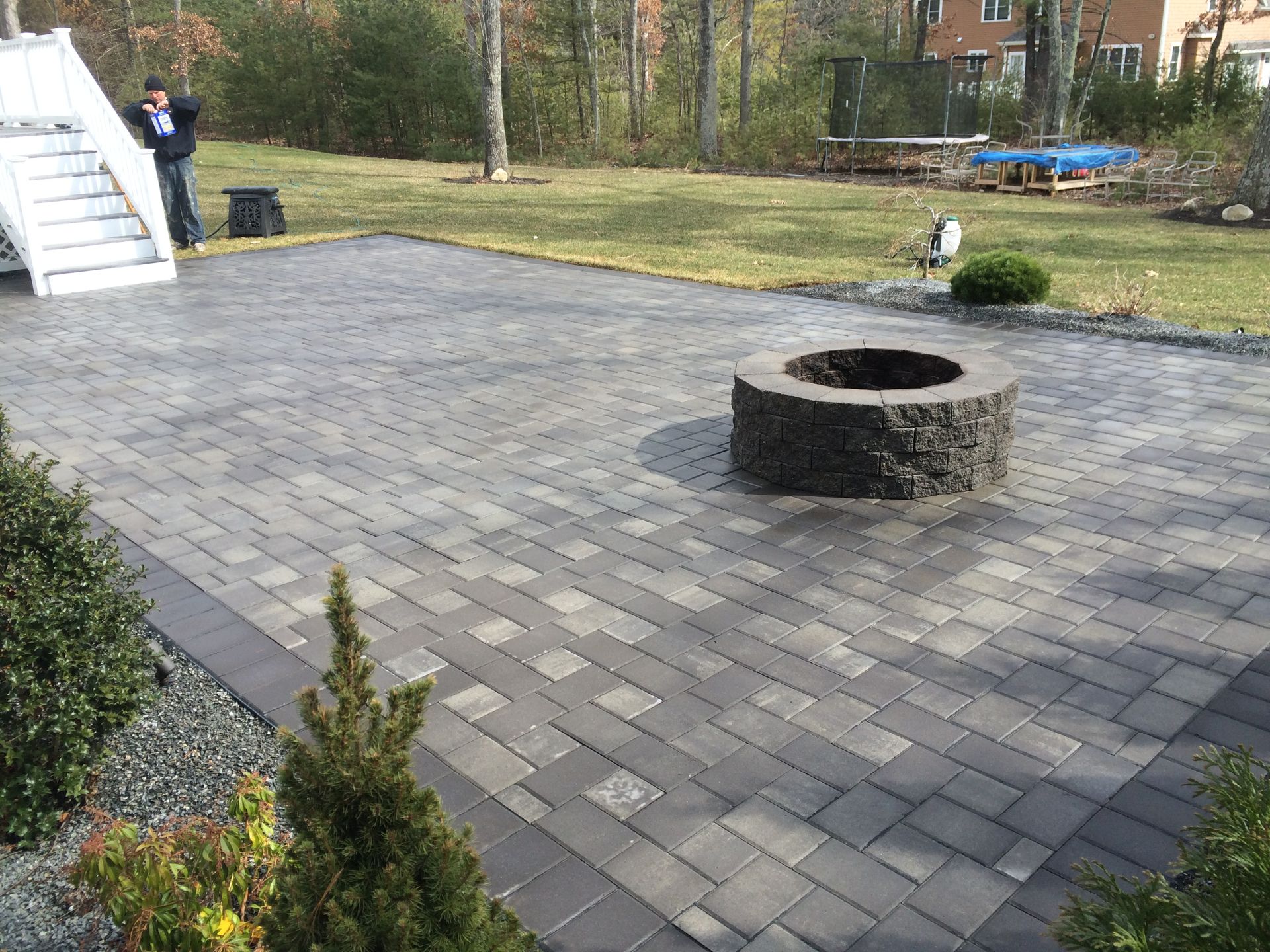 There is a fire pit in the middle of the patio.