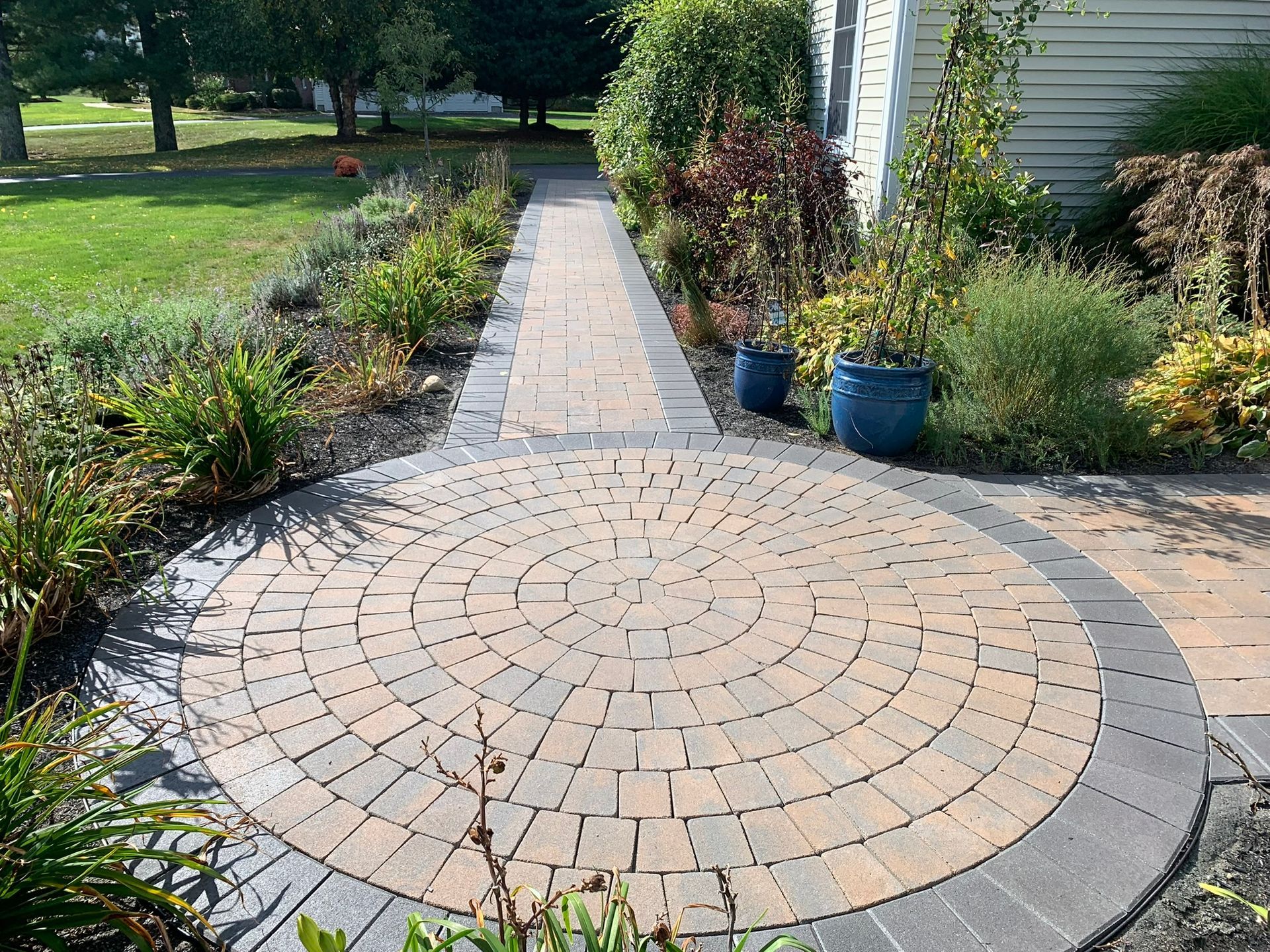 A walkway with a circular brick walkway in the middle