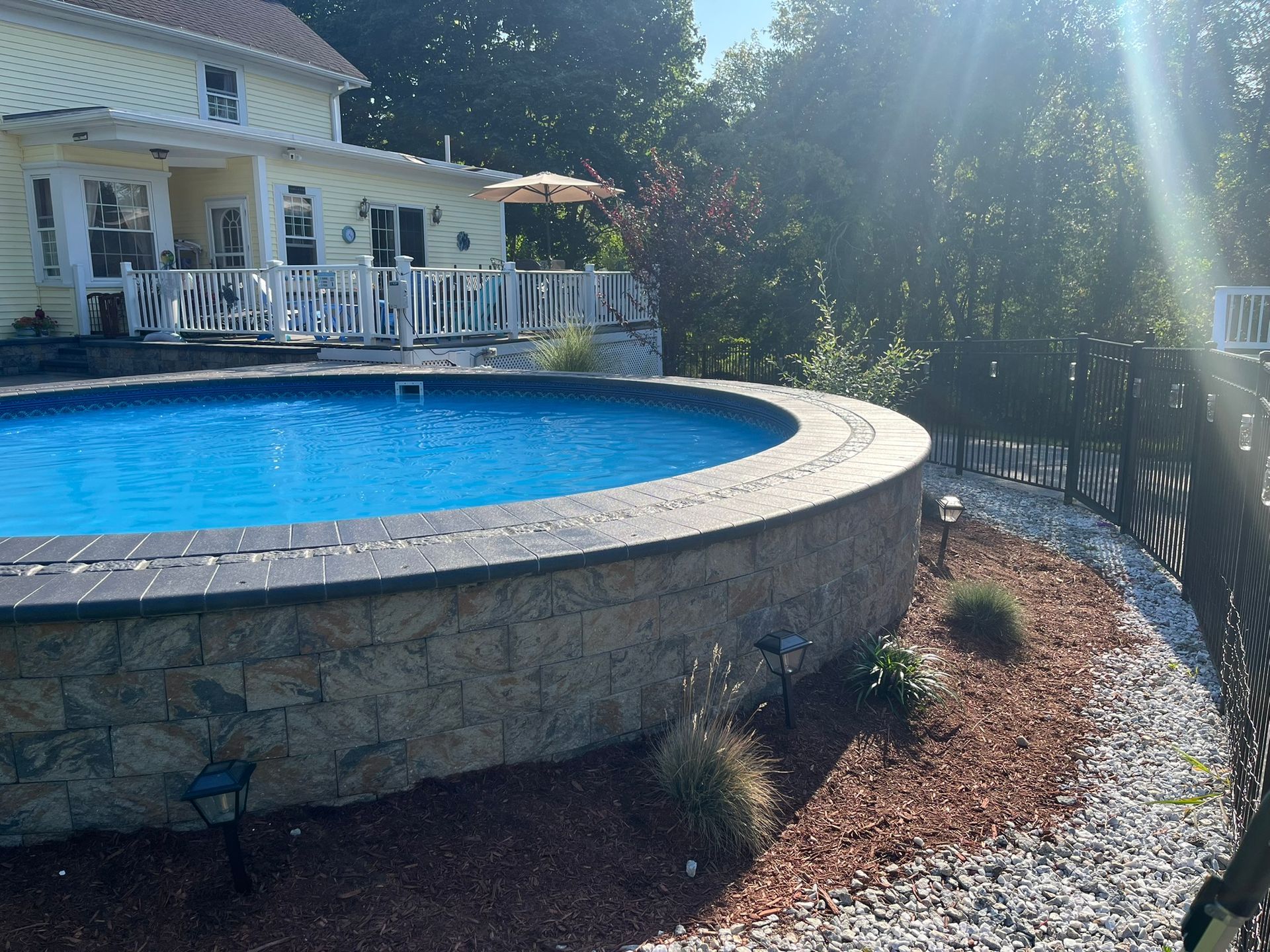A large swimming pool in front of a house