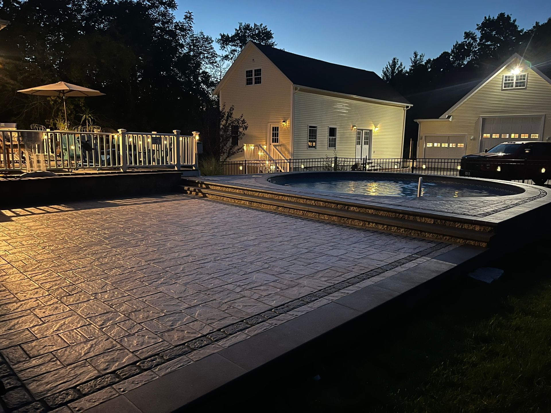 A house with a swimming pool in front of it