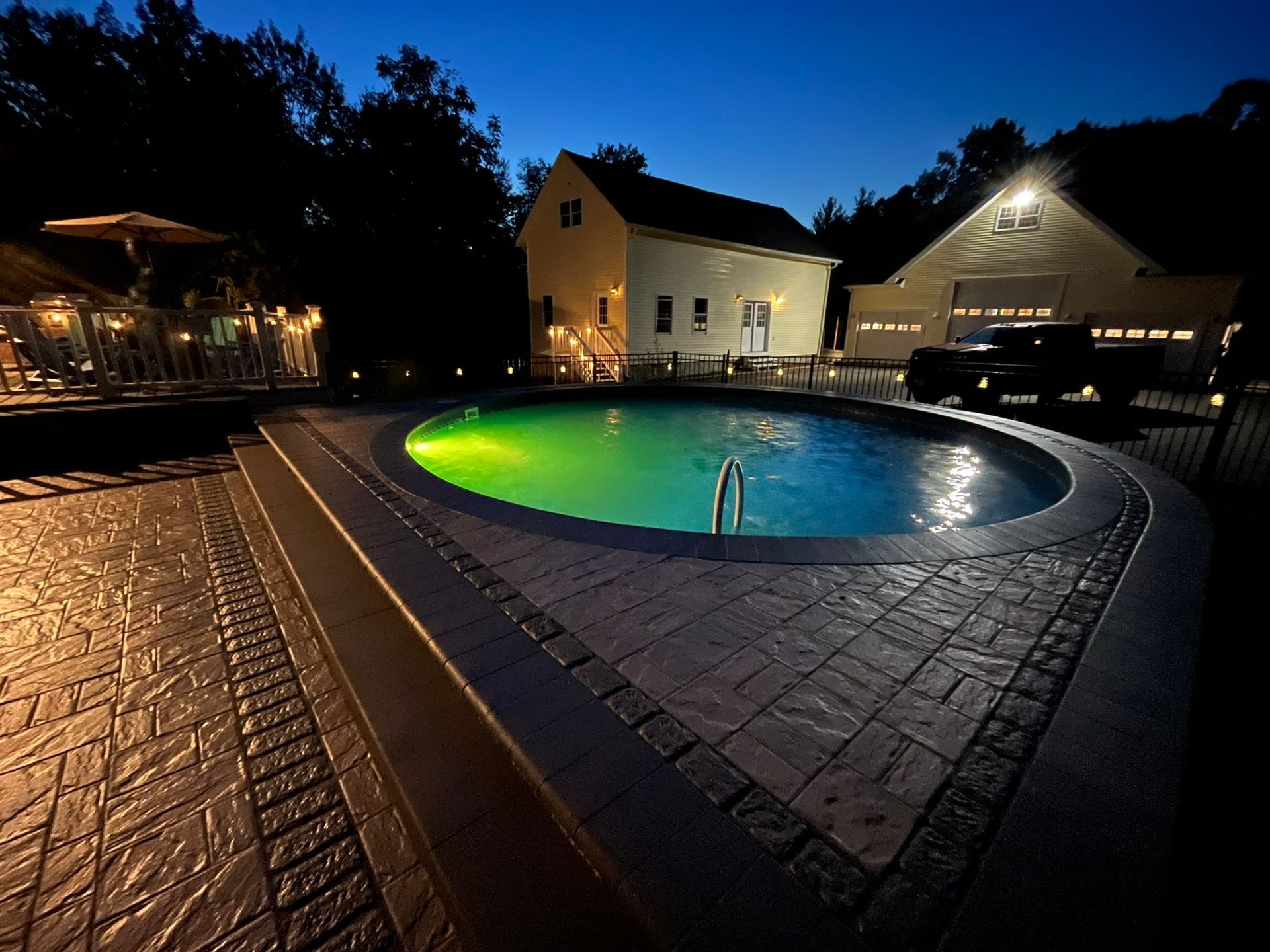 A large swimming pool is lit up at night