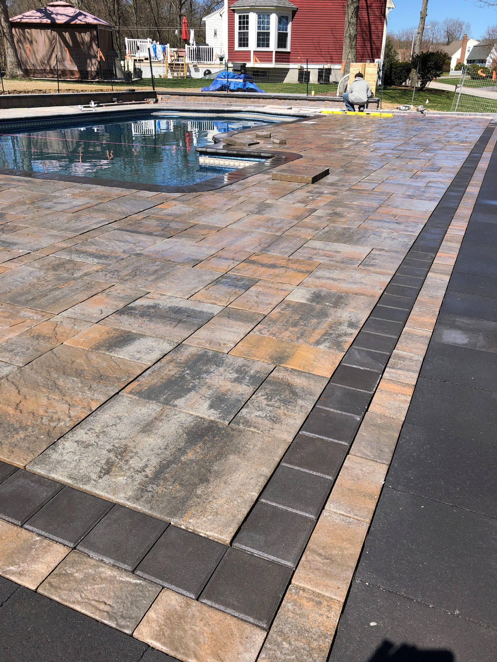 A patio with a pool in the middle of it