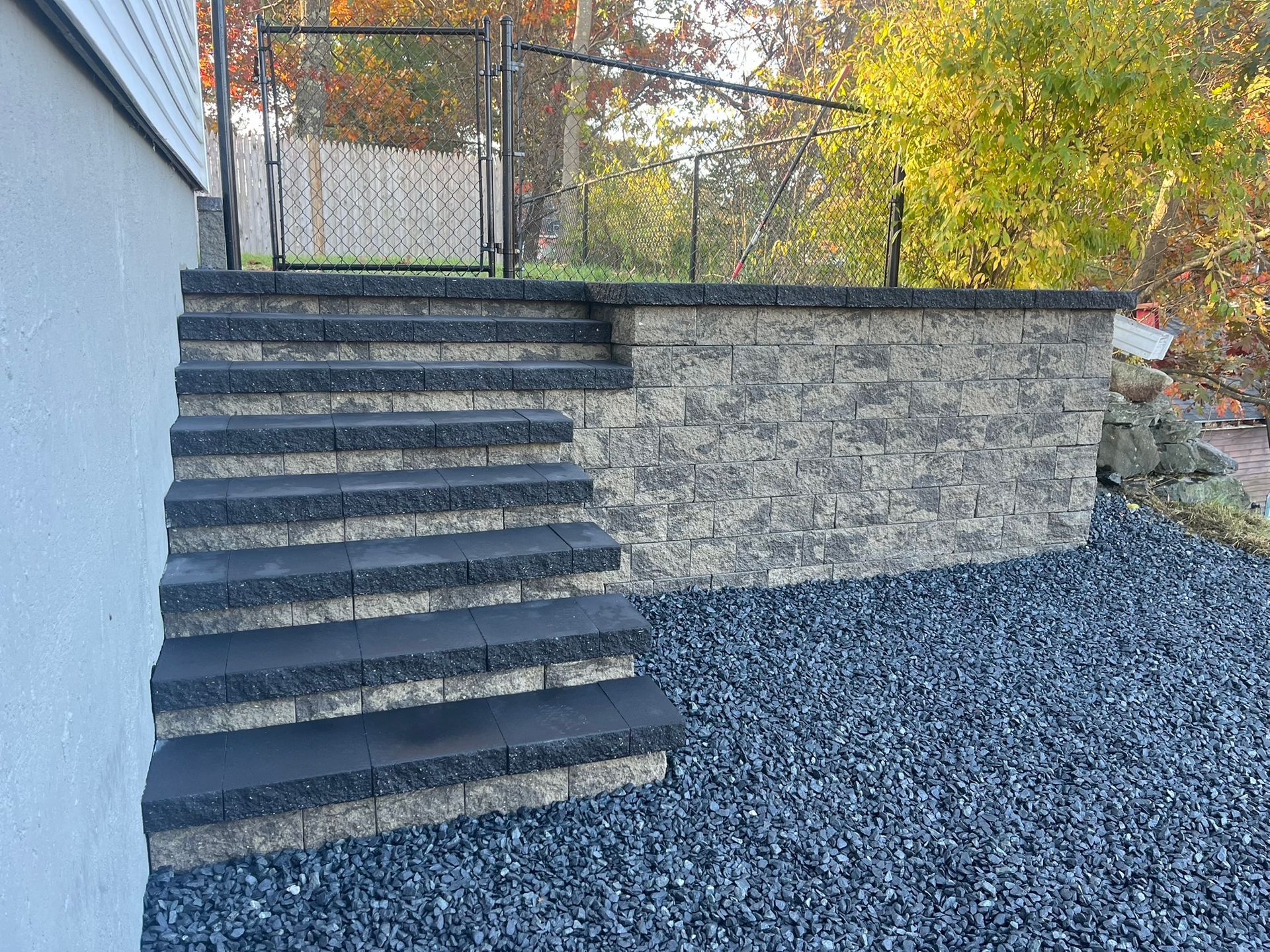 A set of stairs leading up to a stone wall.