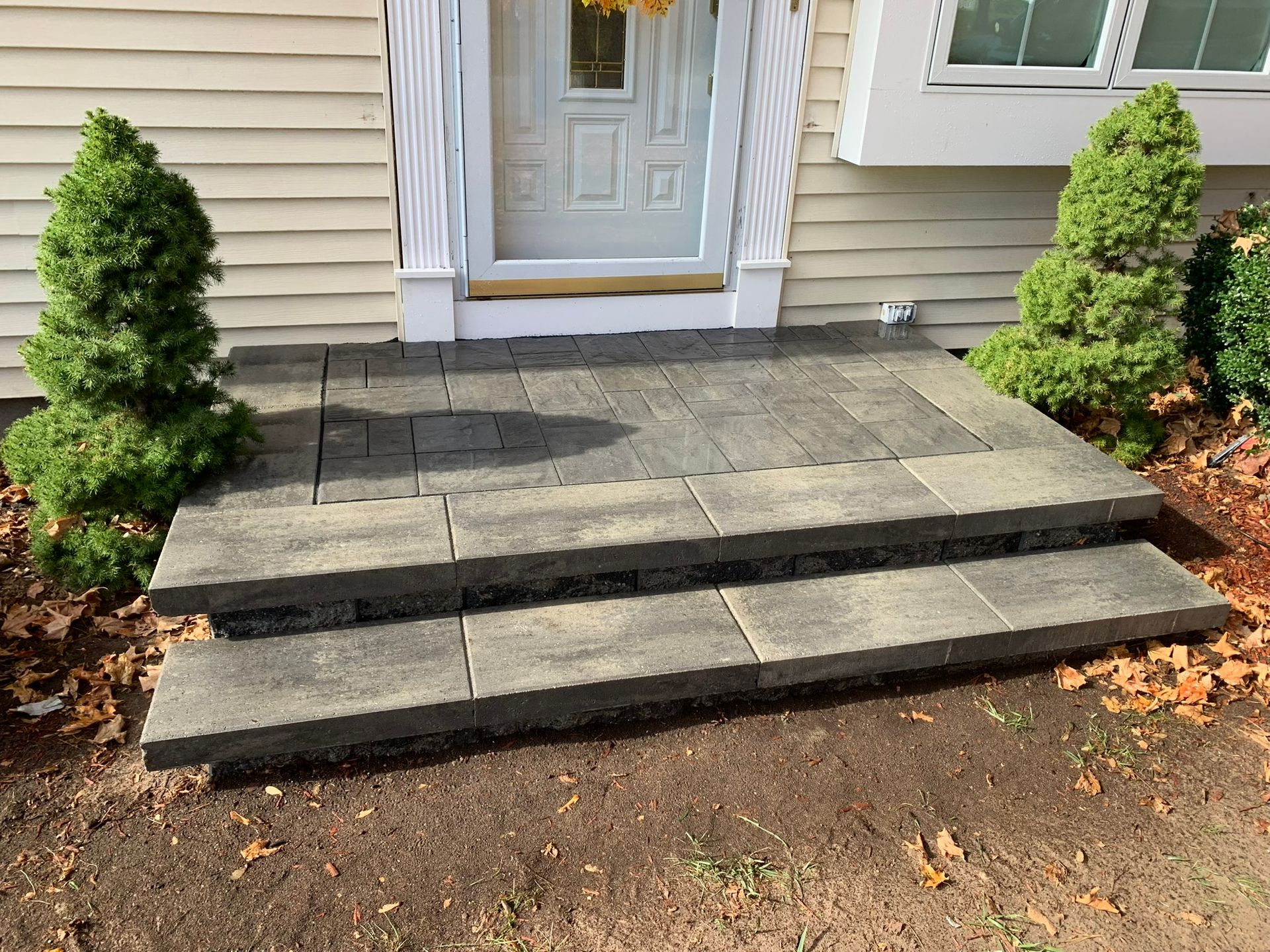 A set of steps leading up to the front door of a house.