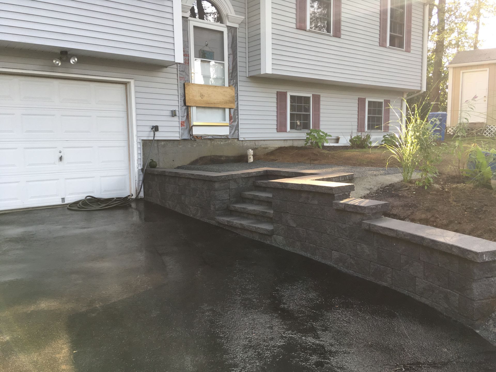 A house with a garage and stairs in front of it.