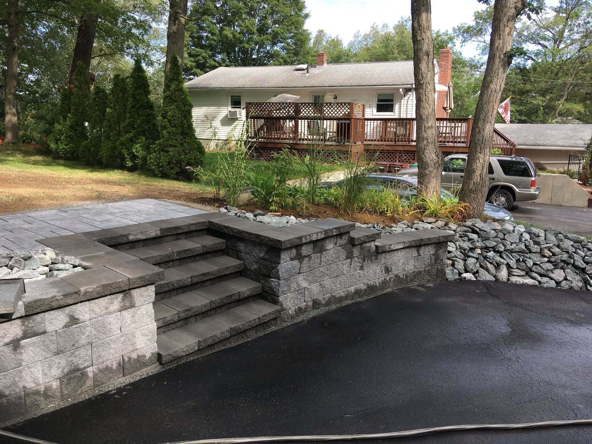 A house with a deck and stairs in front of it.
