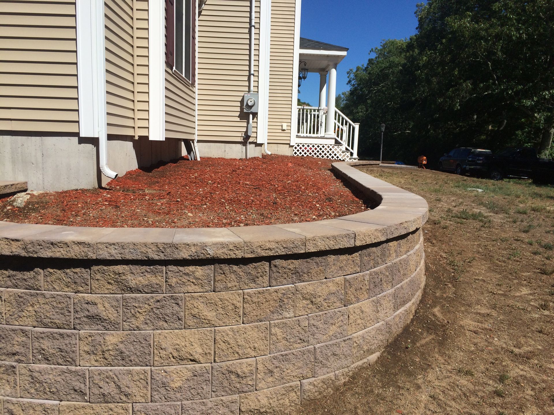 A house with a brick wall in front of it
