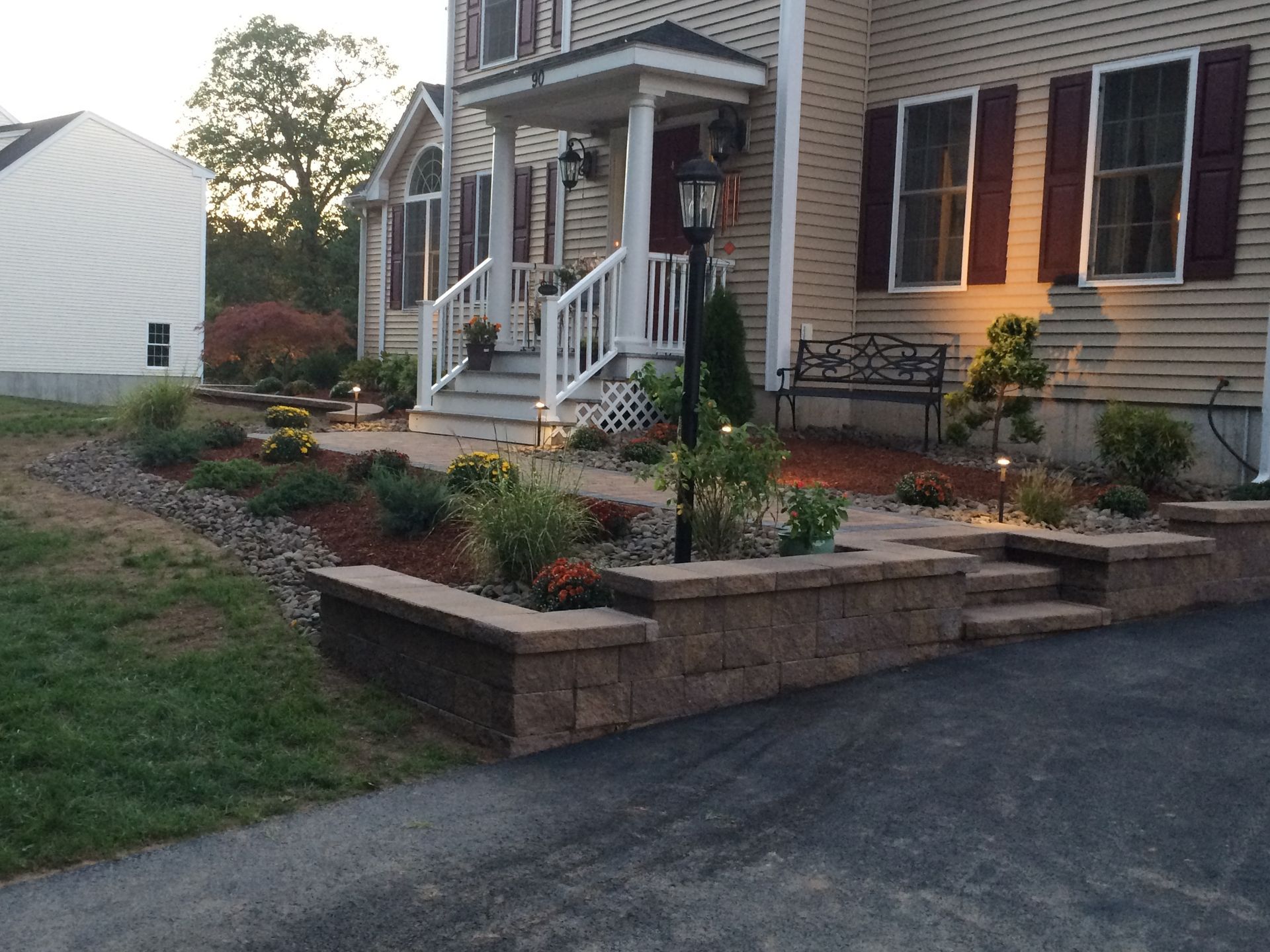 A nice-looking house with a brick wall in front of it
