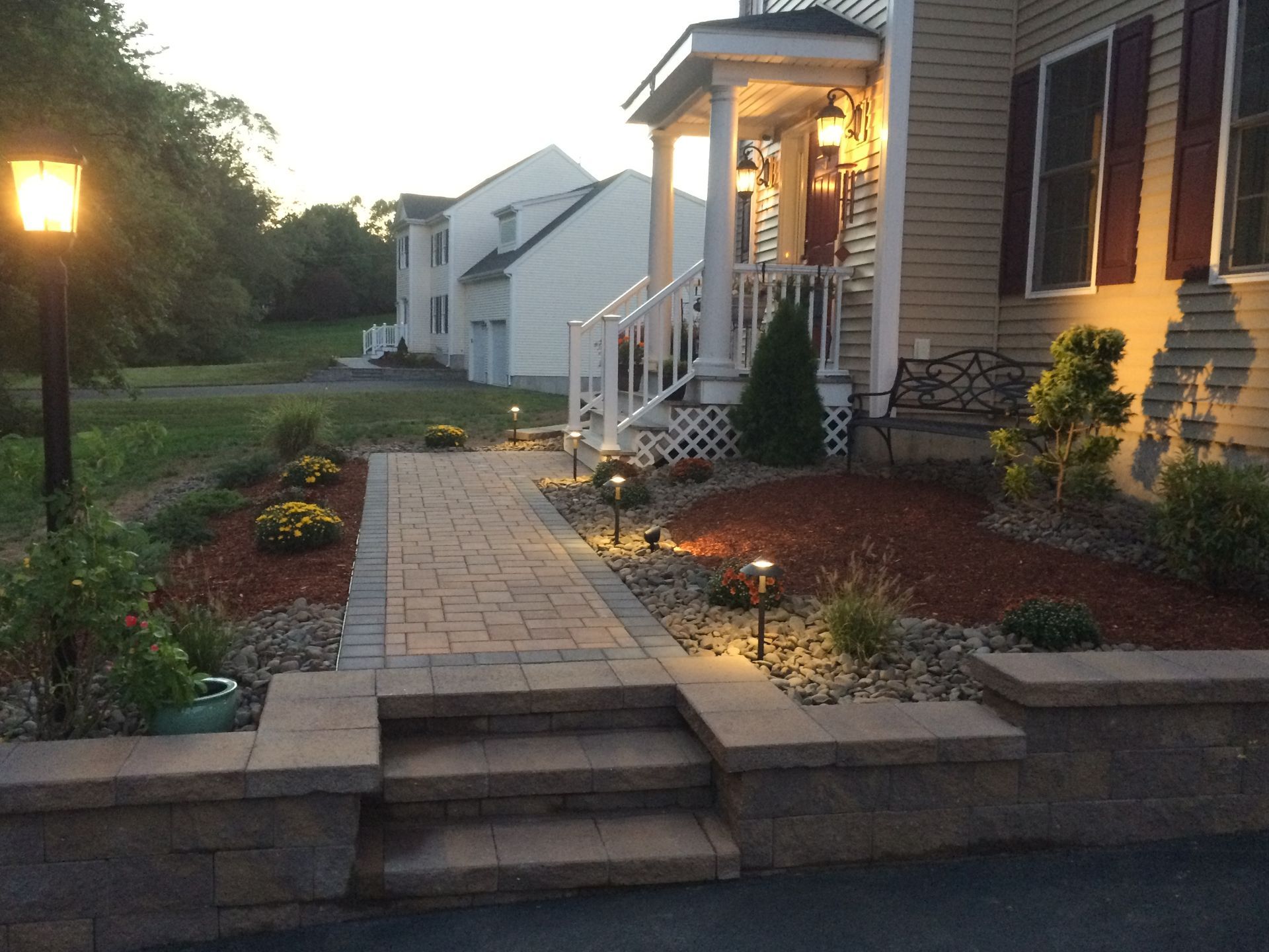 A house with a brick walkway leading to the front door
