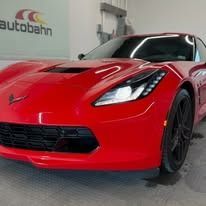 Bright red Chevrolet Corvette sports car in a garage with