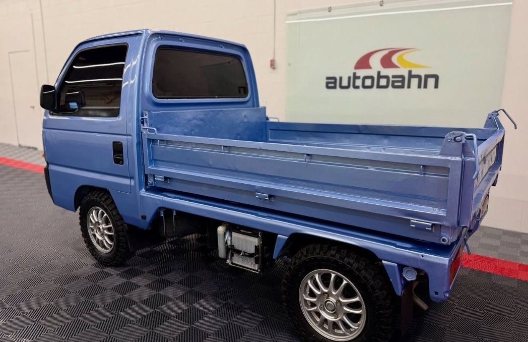 Blue truck with a flatbed.