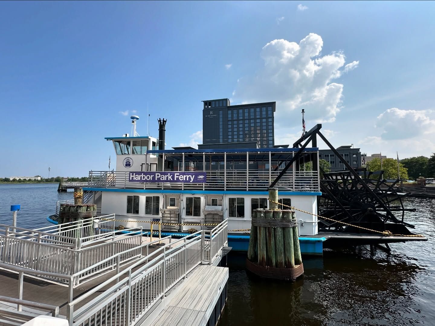 Paddlewheel boat at a dock on the water. 