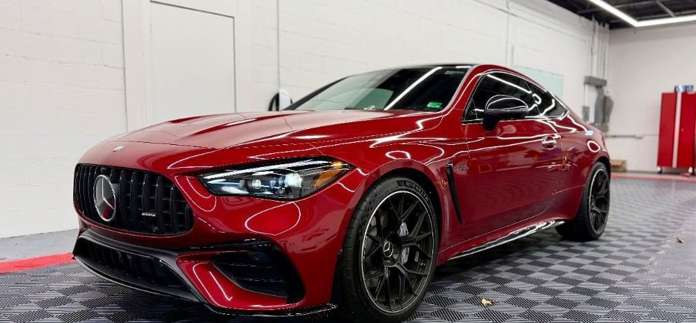 Red Mercedes AMG coupe parked indoors.