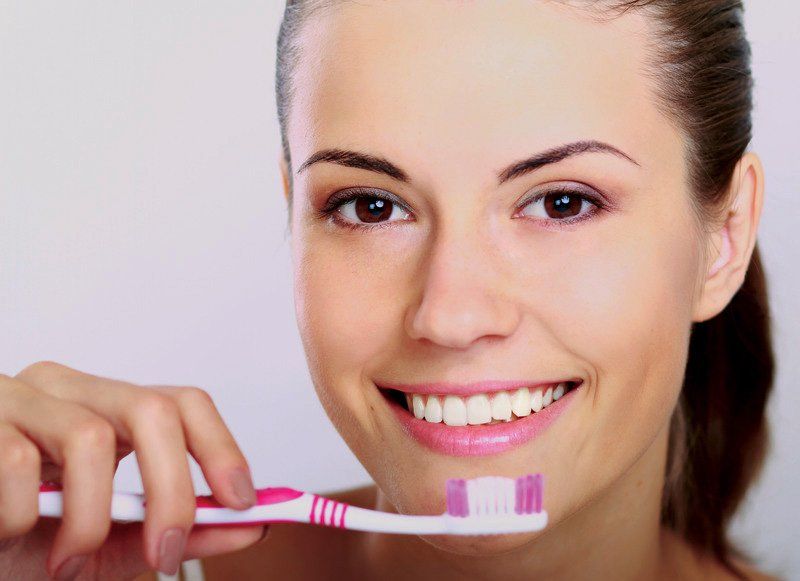 Woman holding a toothbrush