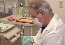 Dentist preparing a tooth crown