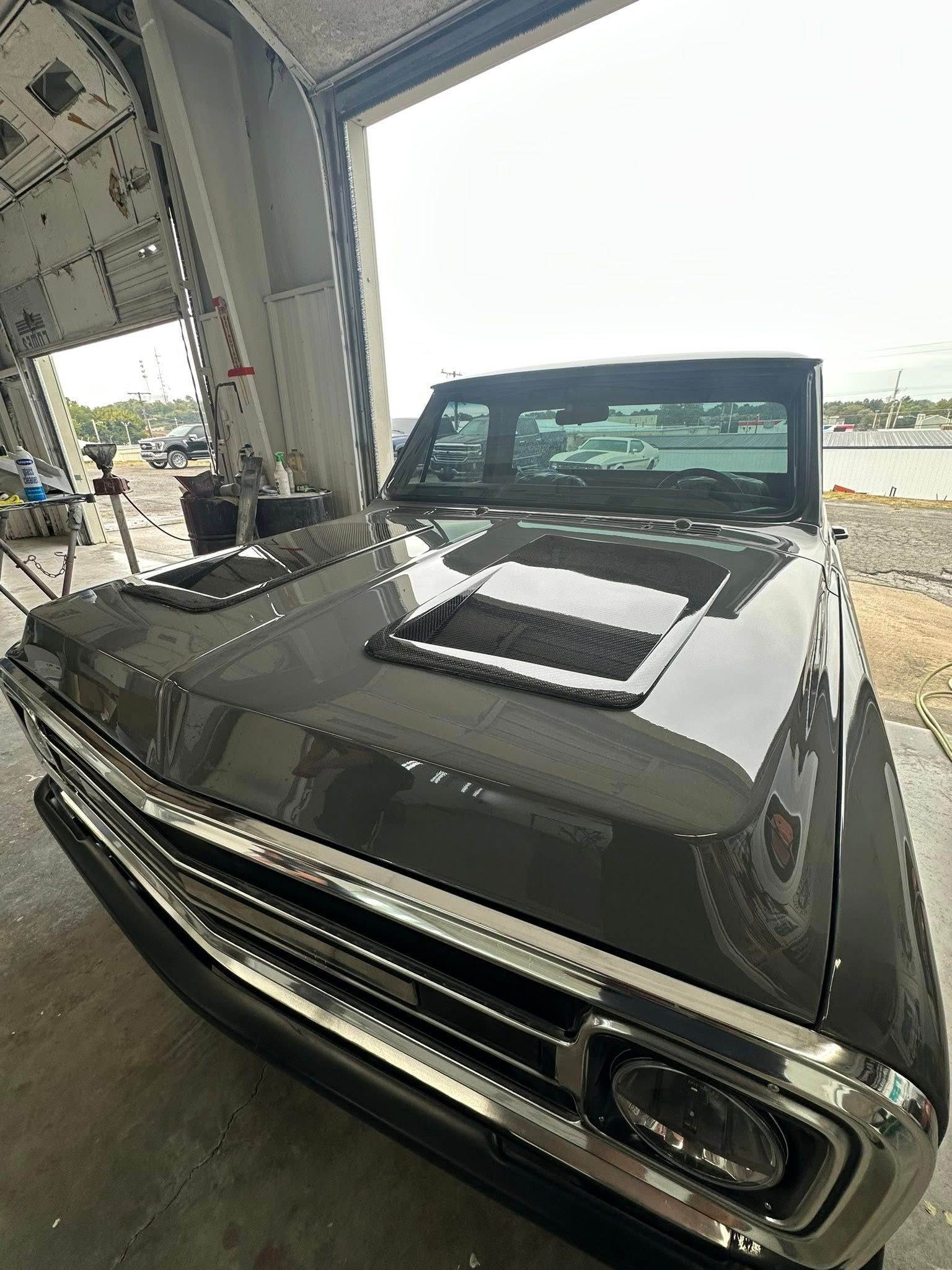 Gray classic pickup truck in a hangar.