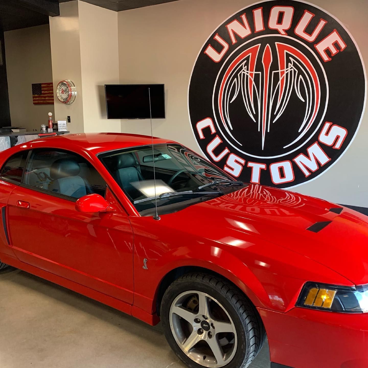 Red Mustang in a shop with a 