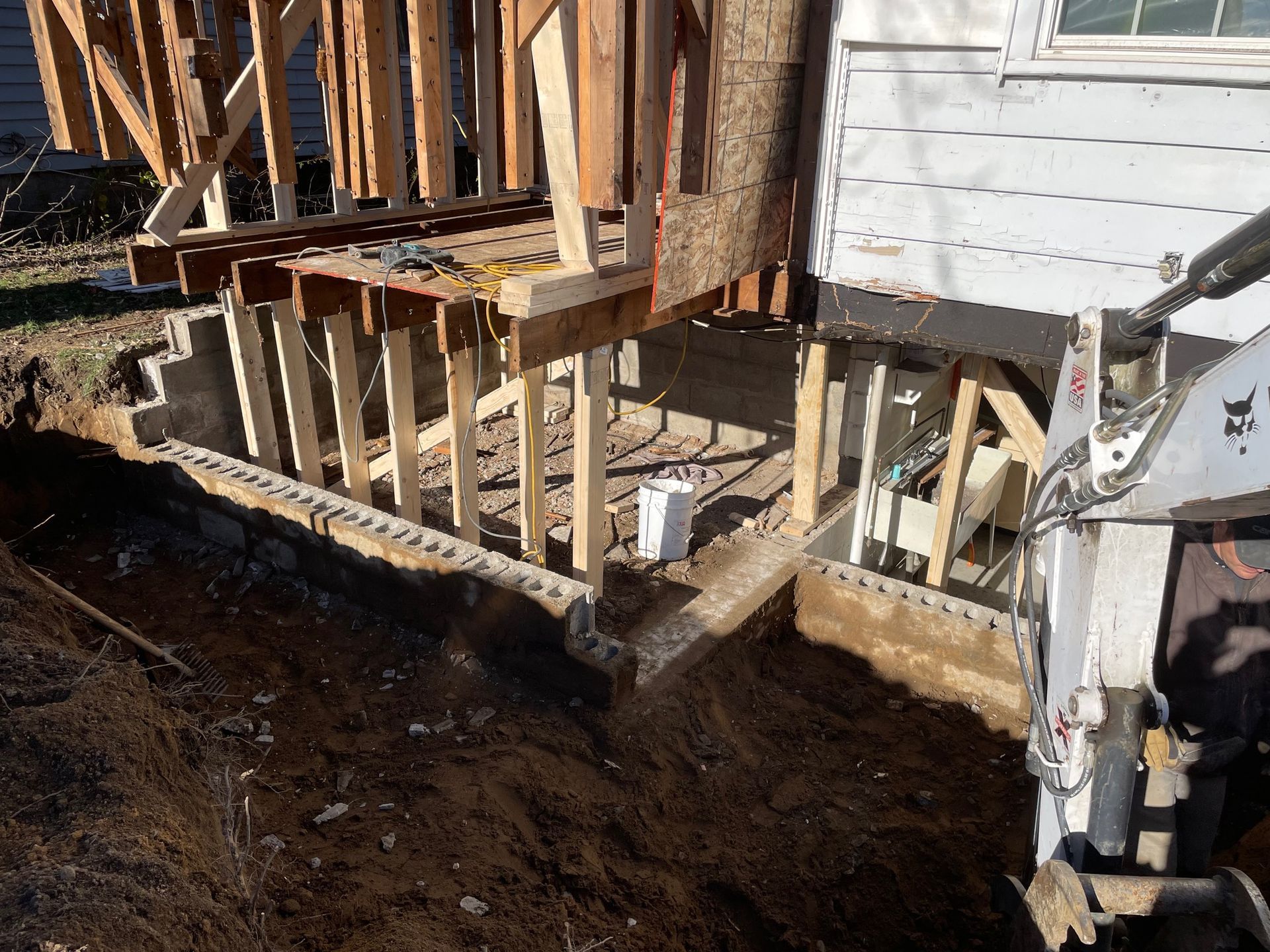 A wooden deck is being built on the side of a house.