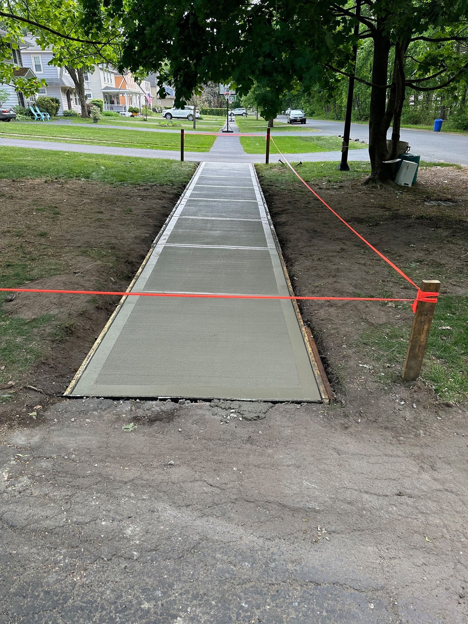 A concrete walkway is being built in a park.