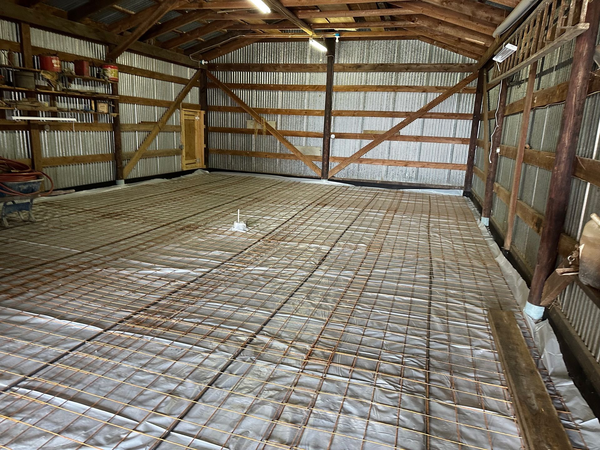 The inside of a barn with a concrete floor.