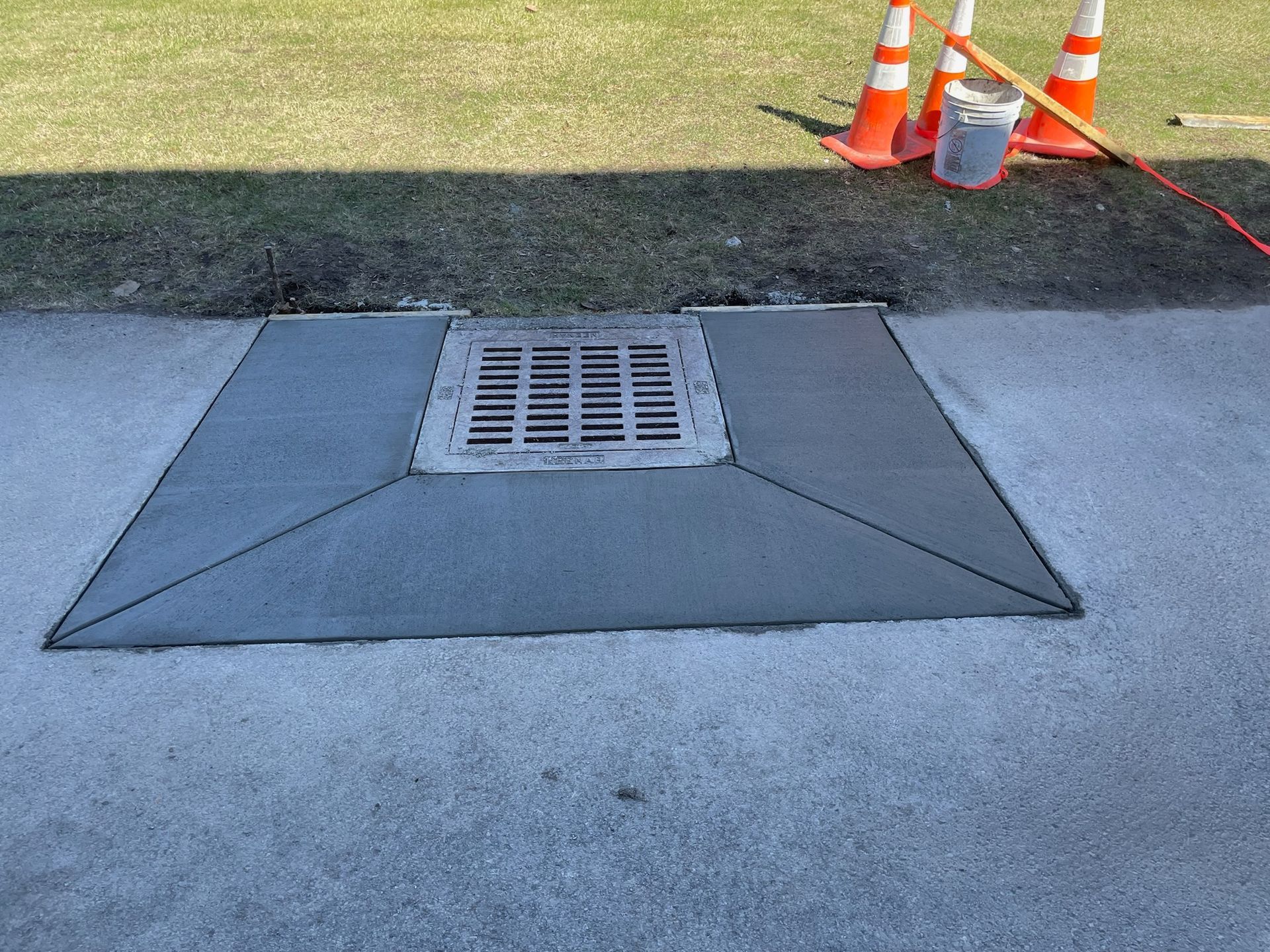 A manhole cover is sitting on top of a concrete surface.
