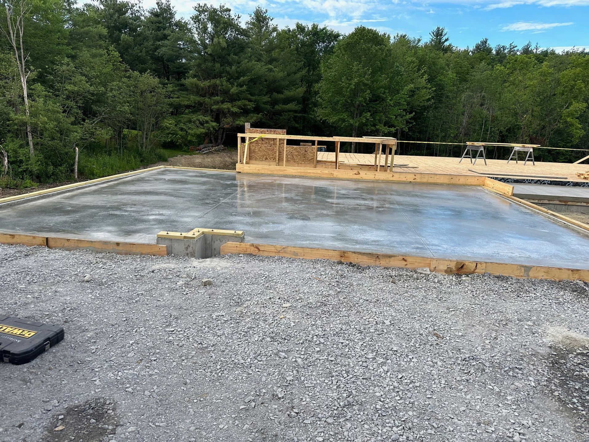 A large concrete slab is sitting on top of a gravel road