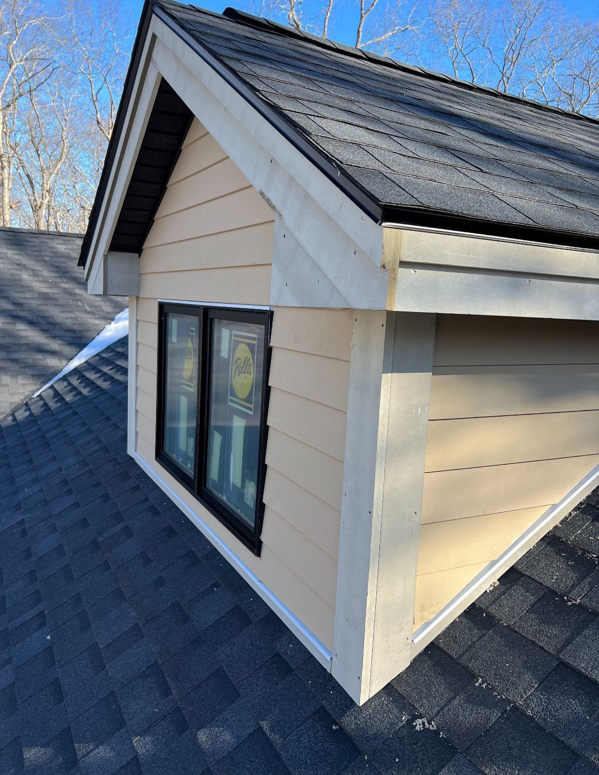 A house with a roof and a window on the side of it.