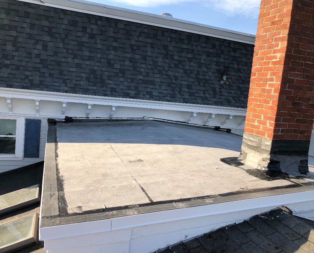 The roof of a building with a chimney on it.