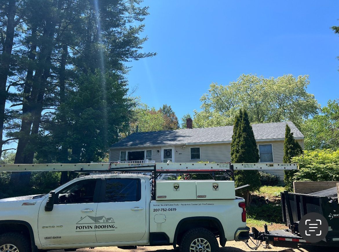 A white truck is parked in front of a house.