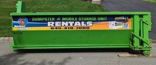 Bright green construction dumpster with “Dumpster & Mobile Storage Rentals” signage on a paved lot