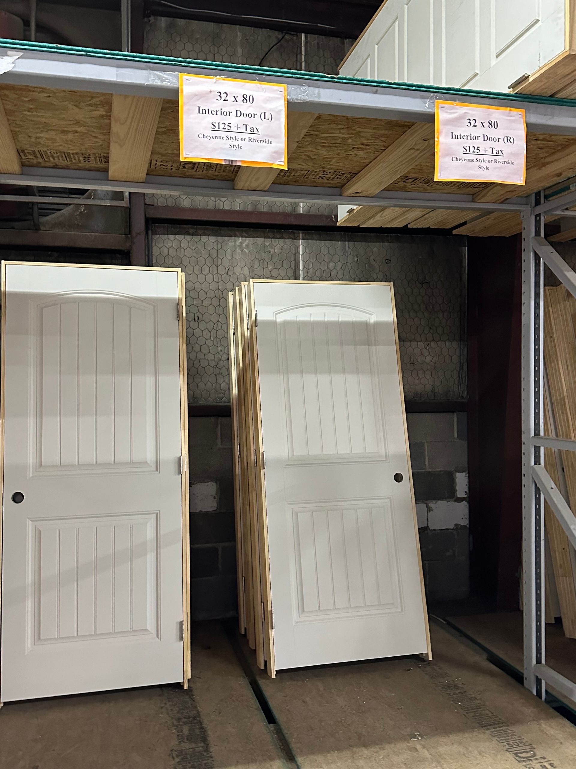 A bunch of white doors stacked on top of each other