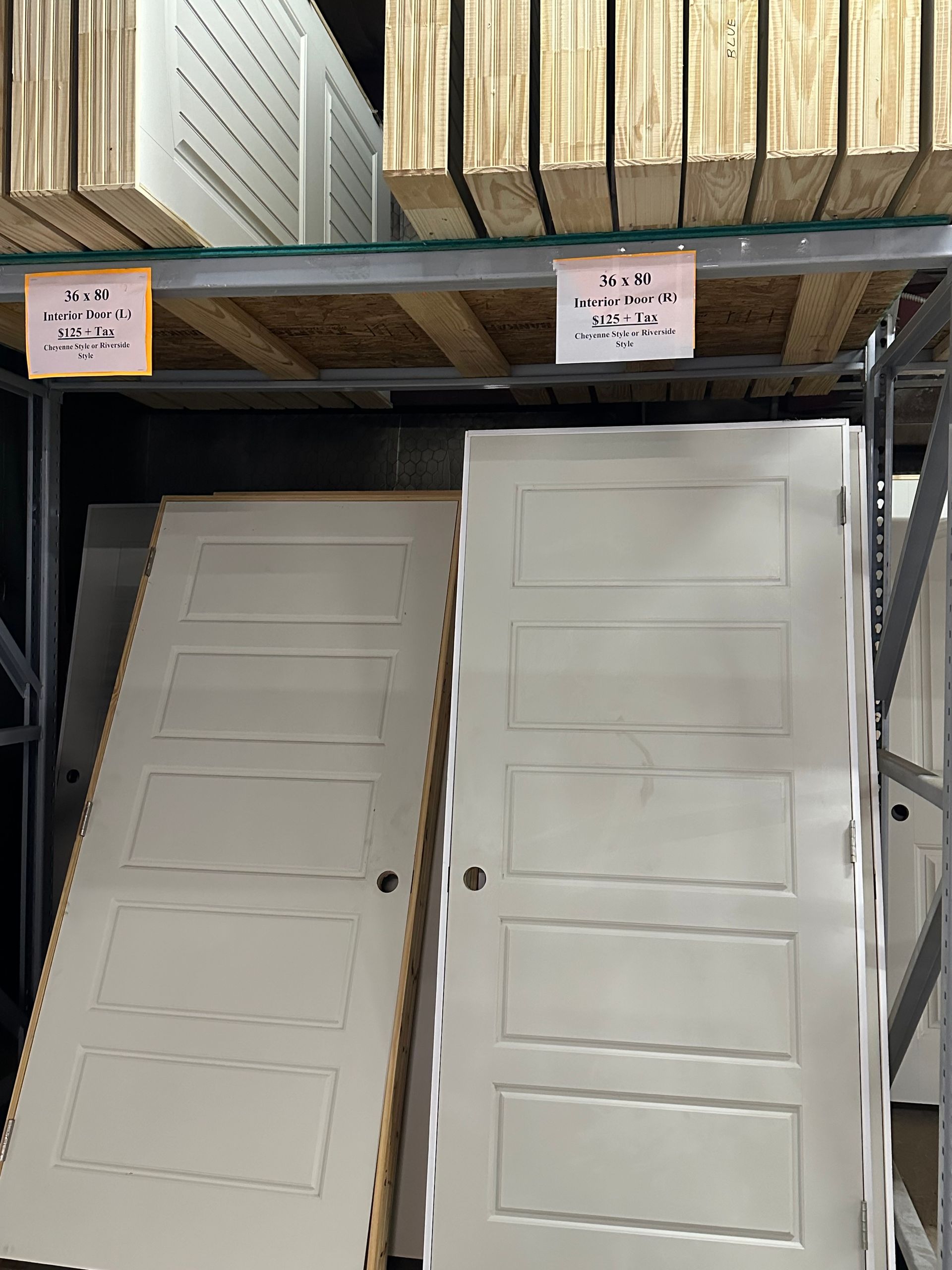 A bunch of white doors are sitting on a shelf in a store.