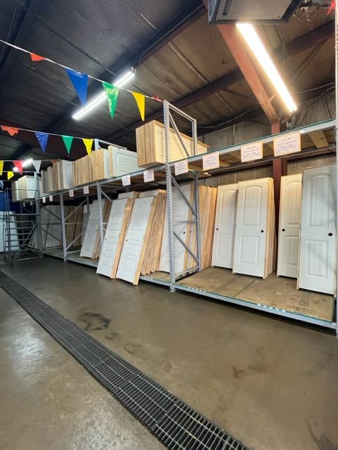 A warehouse filled with lots of doors and flags