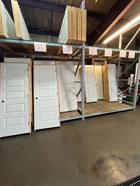 A warehouse filled with lots of white doors