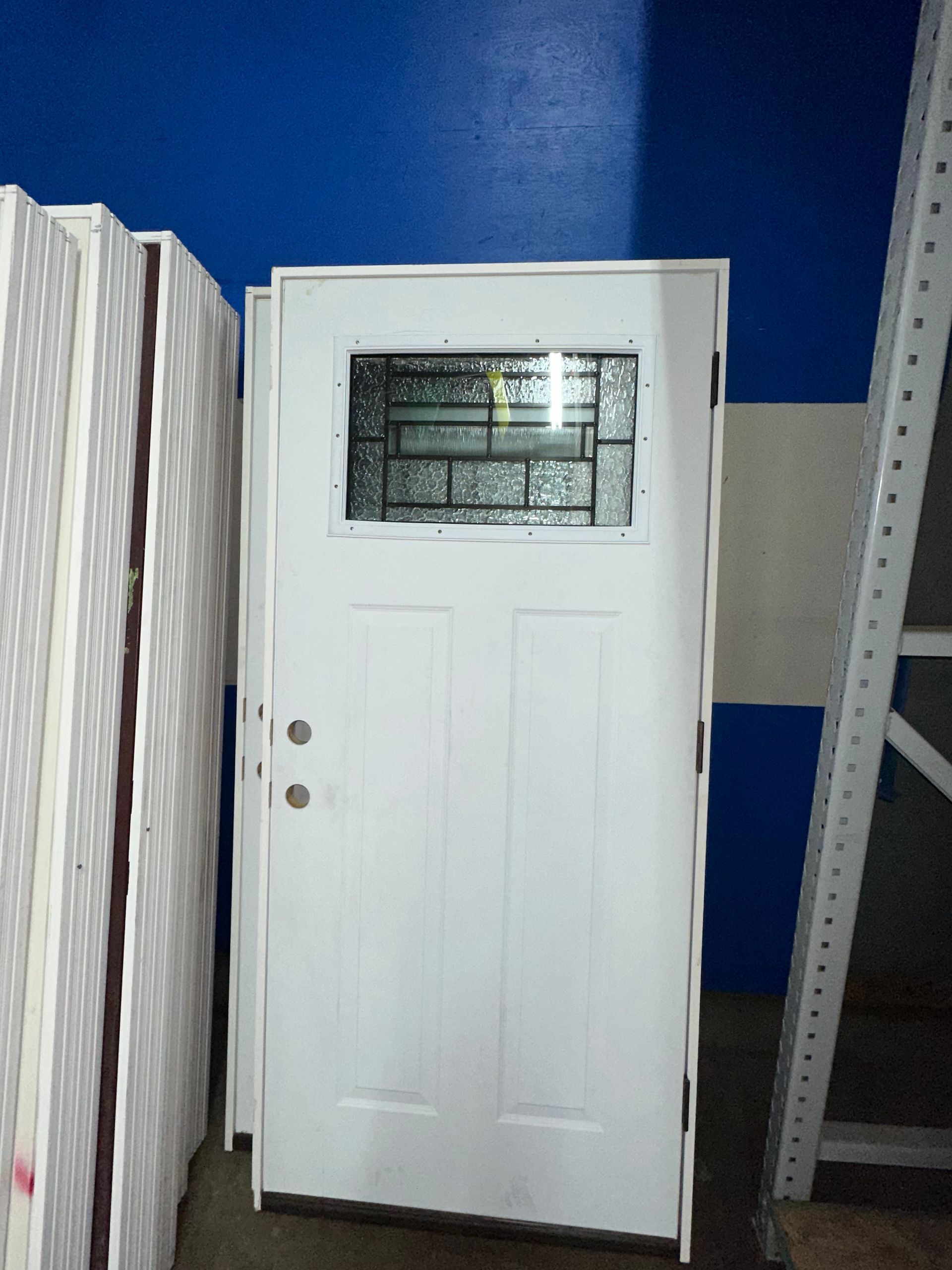 A white door with a stained glass window