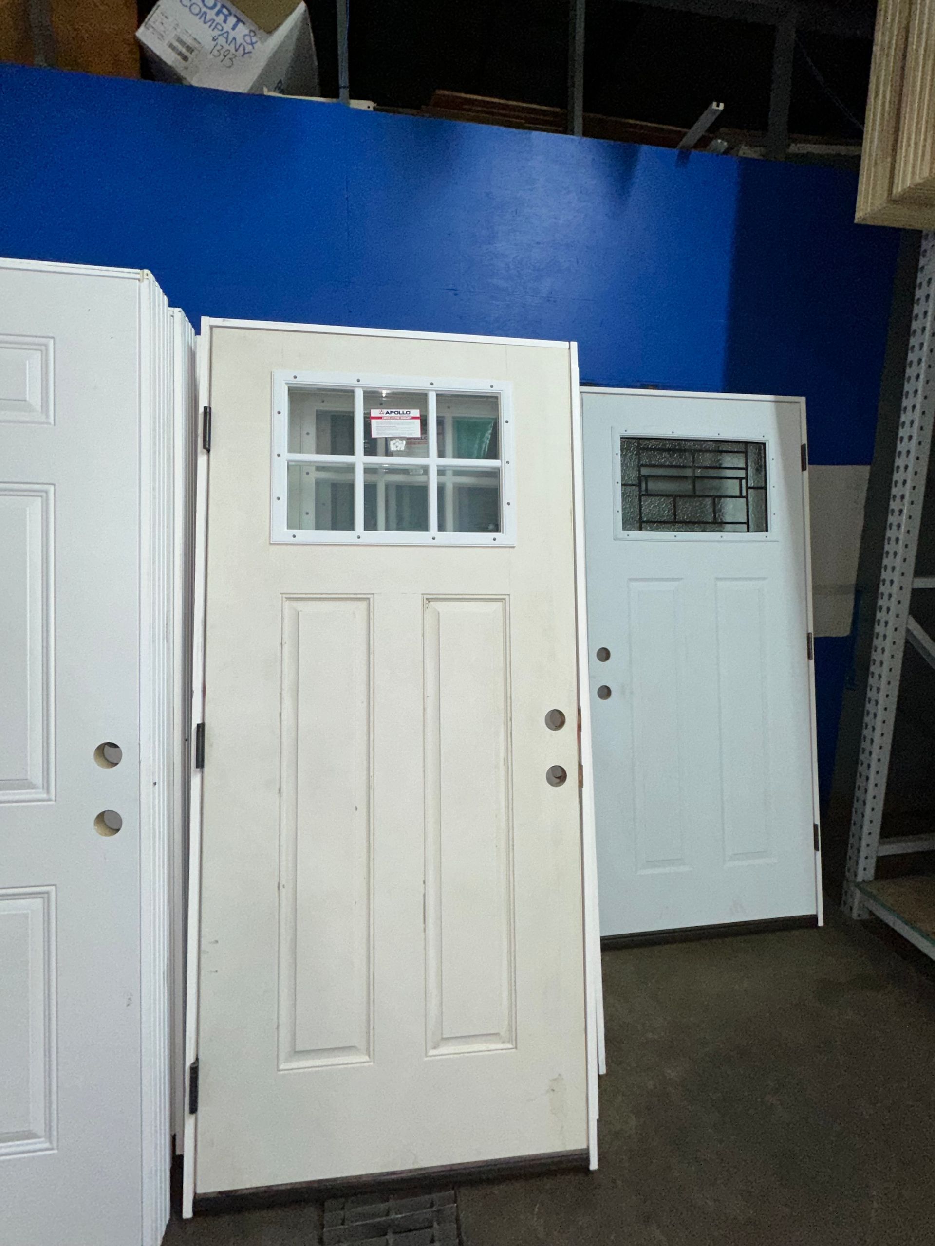 A row of white doors against a blue wall