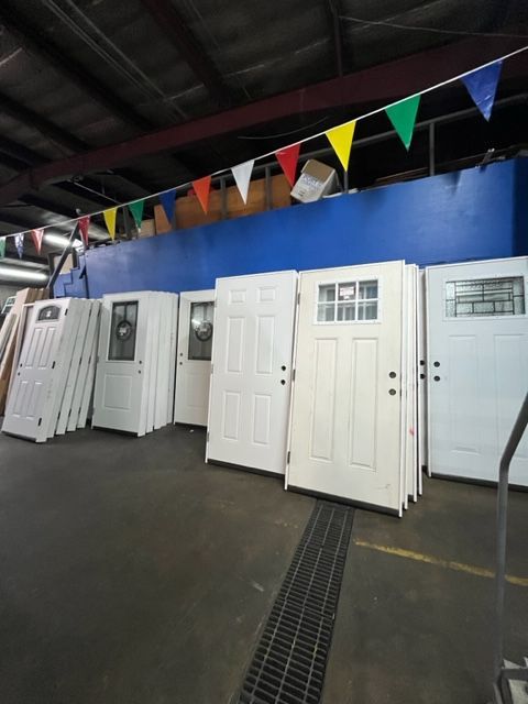 A bunch of white doors stacked on top of each other