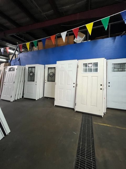 A bunch of white doors are stacked on top of each other