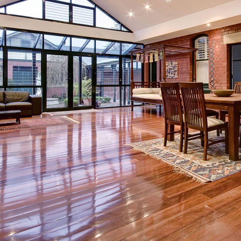 a living room with hardwood floors and a table and chairs