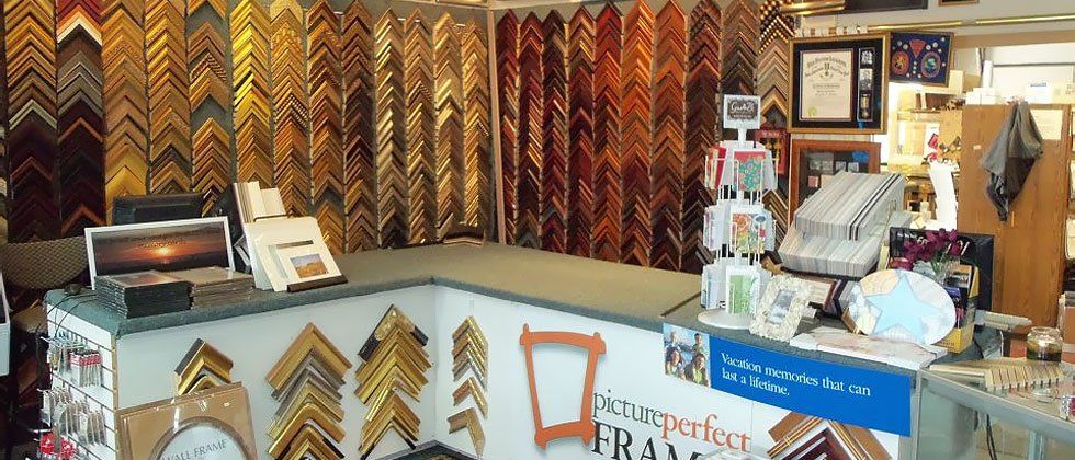 Wall of frame choices at Picture Perfect Frames Inc