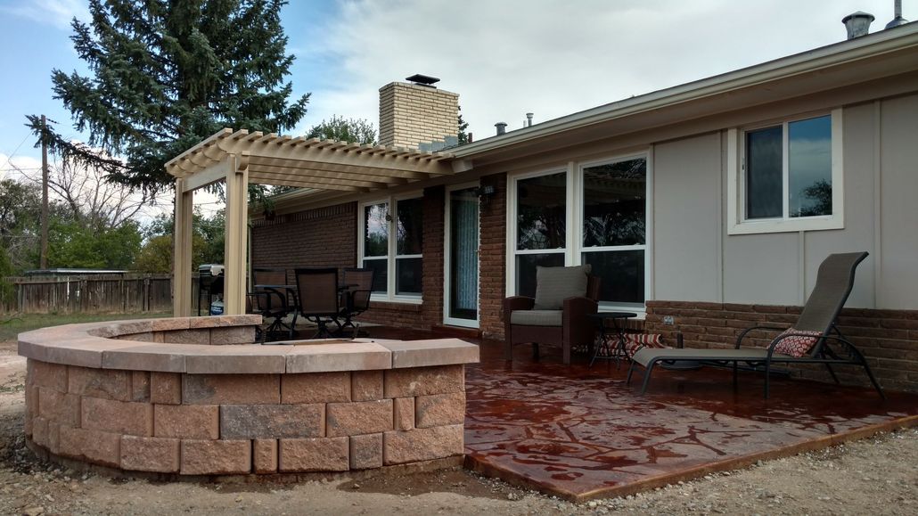 Backyard patio with fire pit, pergola, and house. Brick, concrete, and beige colors.