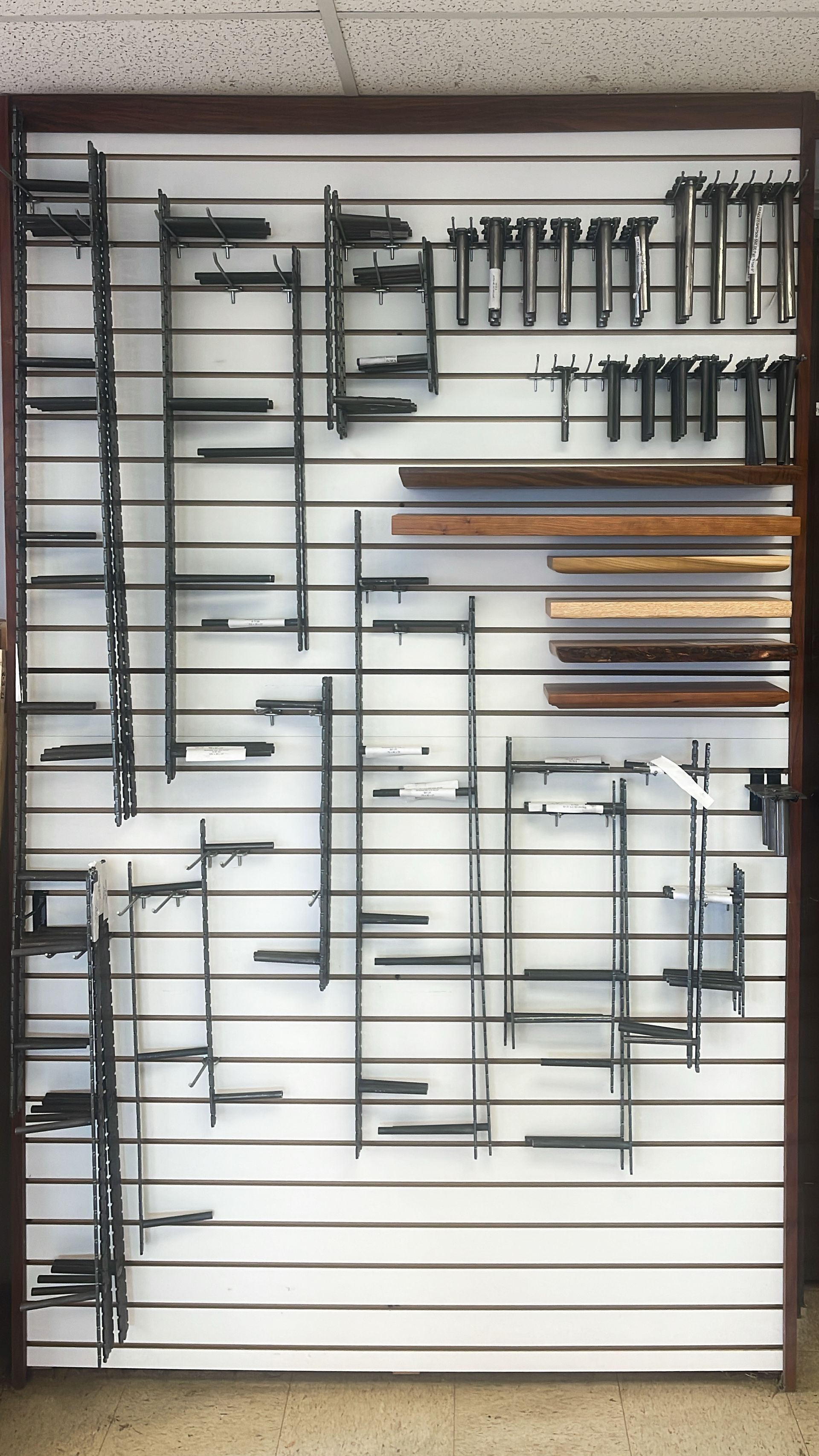Display rack of various metal picture frame samples in a shop setting.