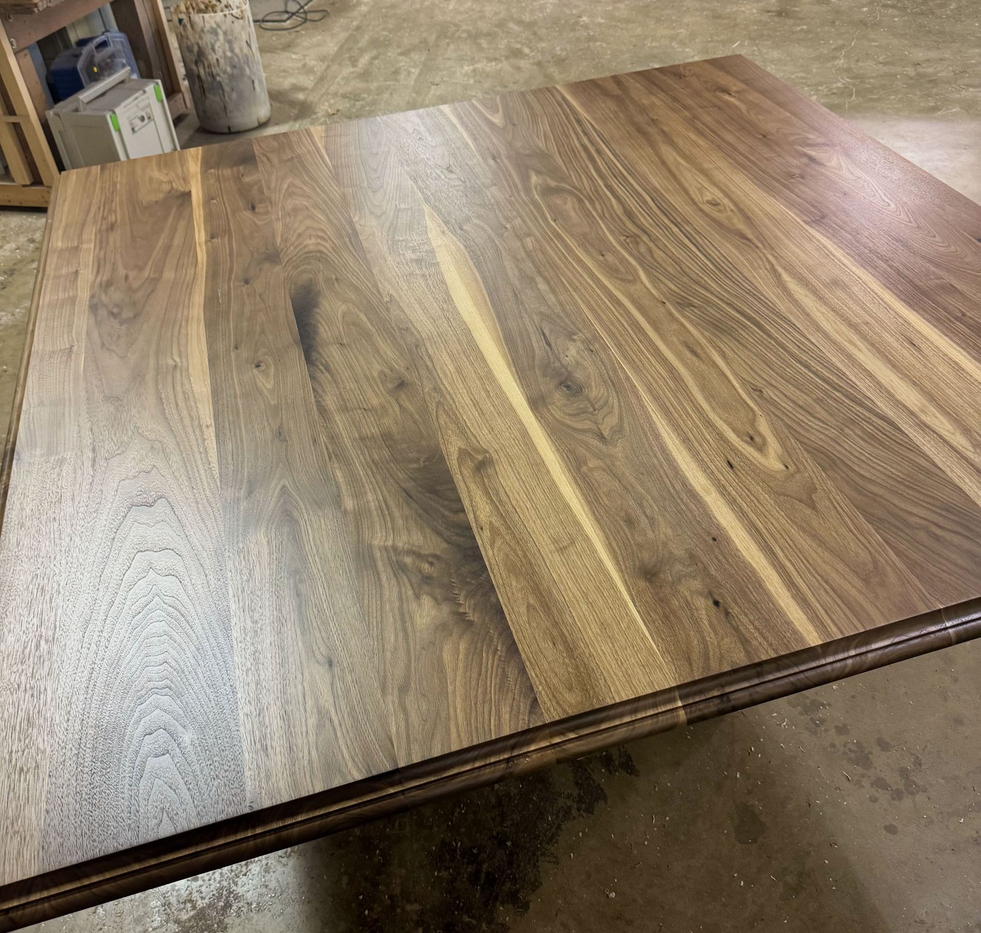 Square wooden table with dark brown finish.