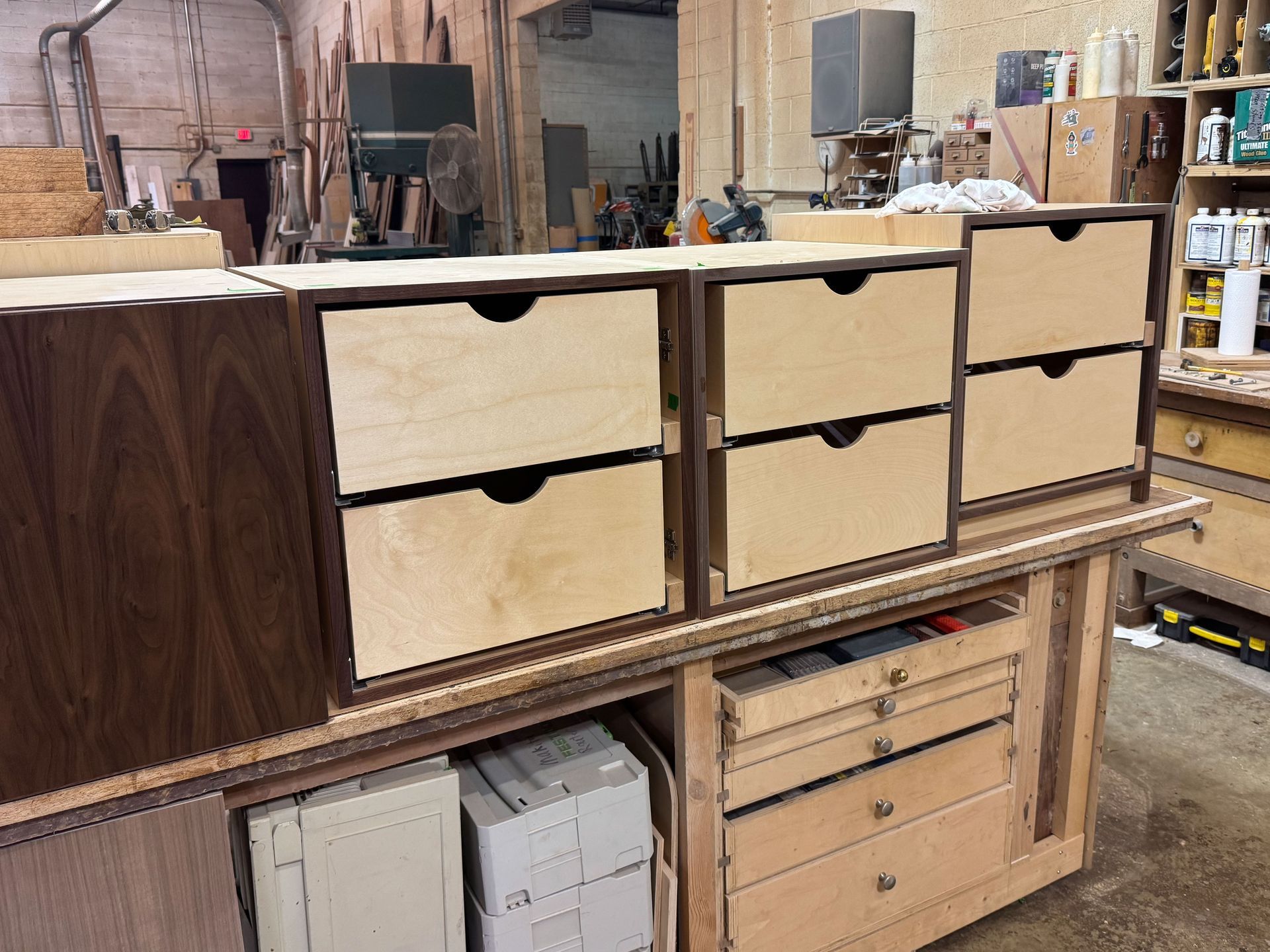 Wooden drawers and cabinet boxes in a woodworking shop.