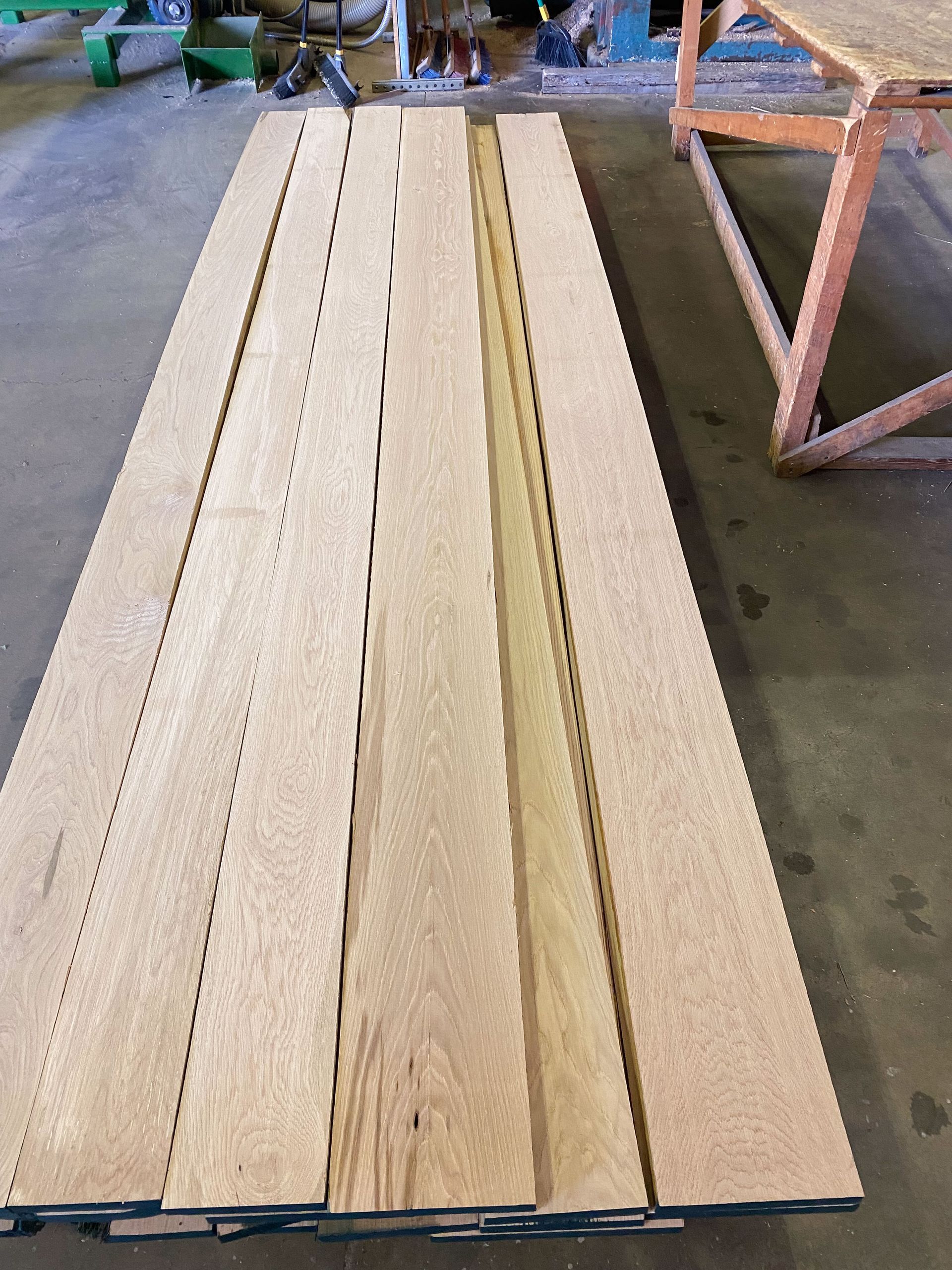 Wooden planks stacked on a factory floor.